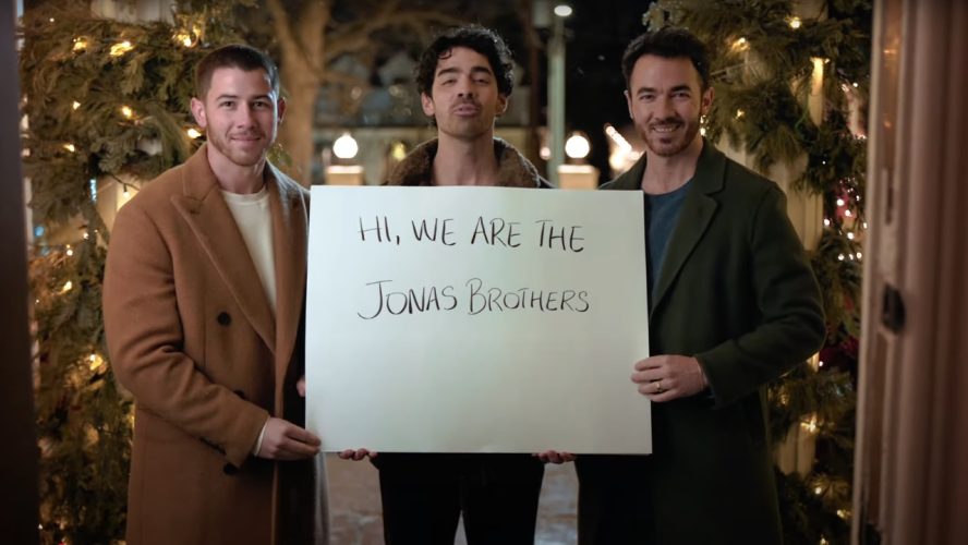 The Jonas Brothers Went Full Love Actually To Announce Their Return To Disney, And Christmas Movie Fans Will Be Pumped