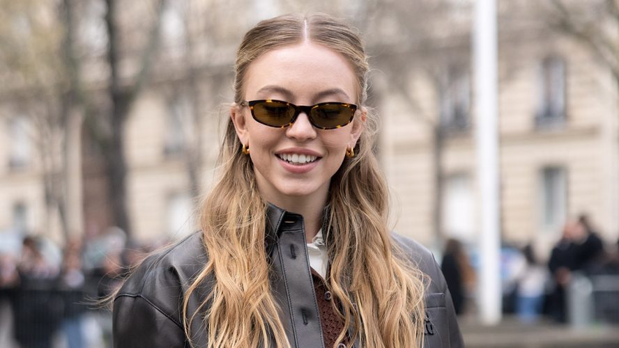 Sydney Sweeney Totally Brought Back Leg Warmers During Paris Fashion Week, And I’m Shocked At How Great It Looks With Her Miniskirt